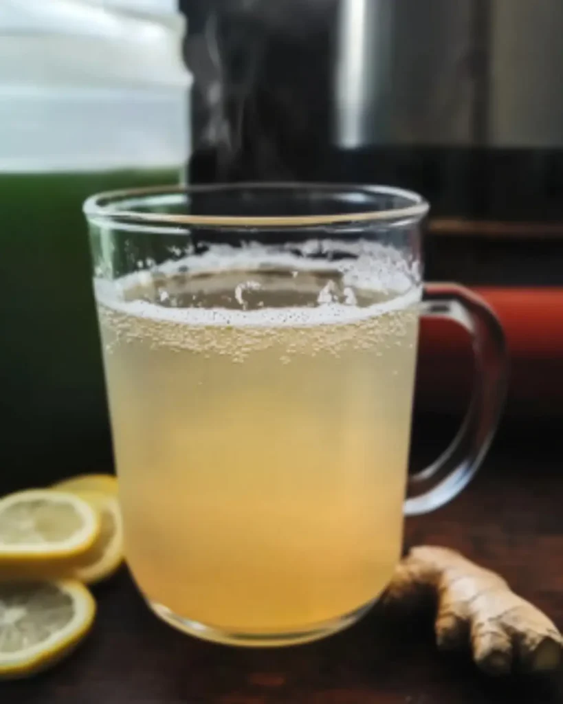 Hot Japanese detox drink with lemon and ginger, steam rising in clear mug