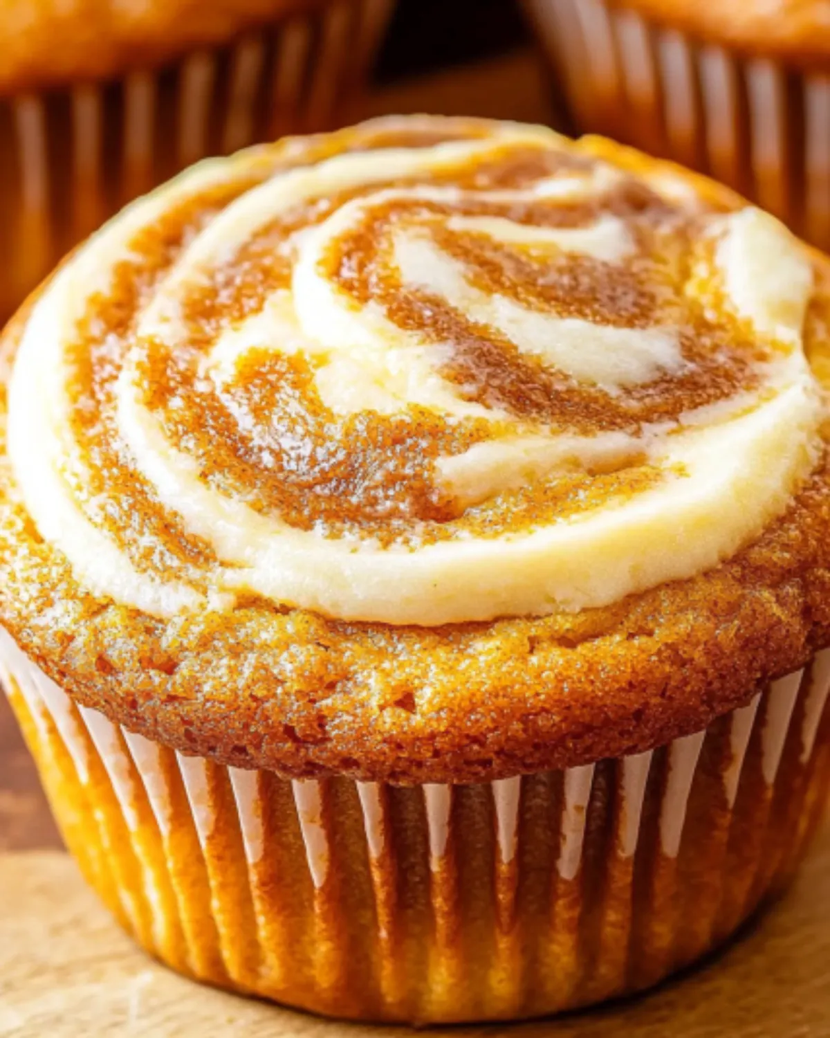 Close-up of pumpkin muffin top with swirled cream cheese filling