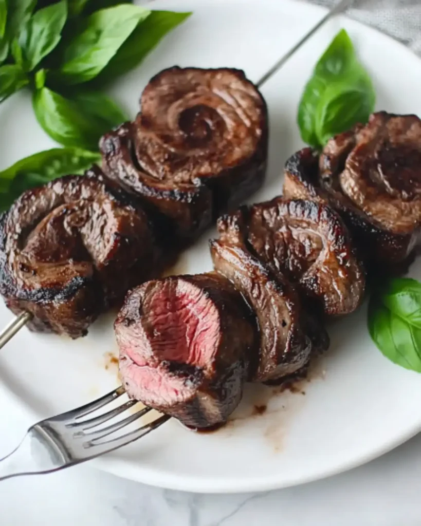 Brazilian picanha steak skewers sliced to reveal juicy medium-rare center