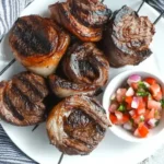 Char-grilled Brazilian picanha steaks on skewers with salsa on the side