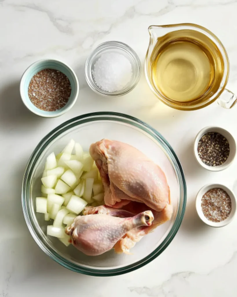 Ingredients for chicken bone broth including raw chicken, chopped onions, apple cider vinegar, salt, and pepper on a marble counter

