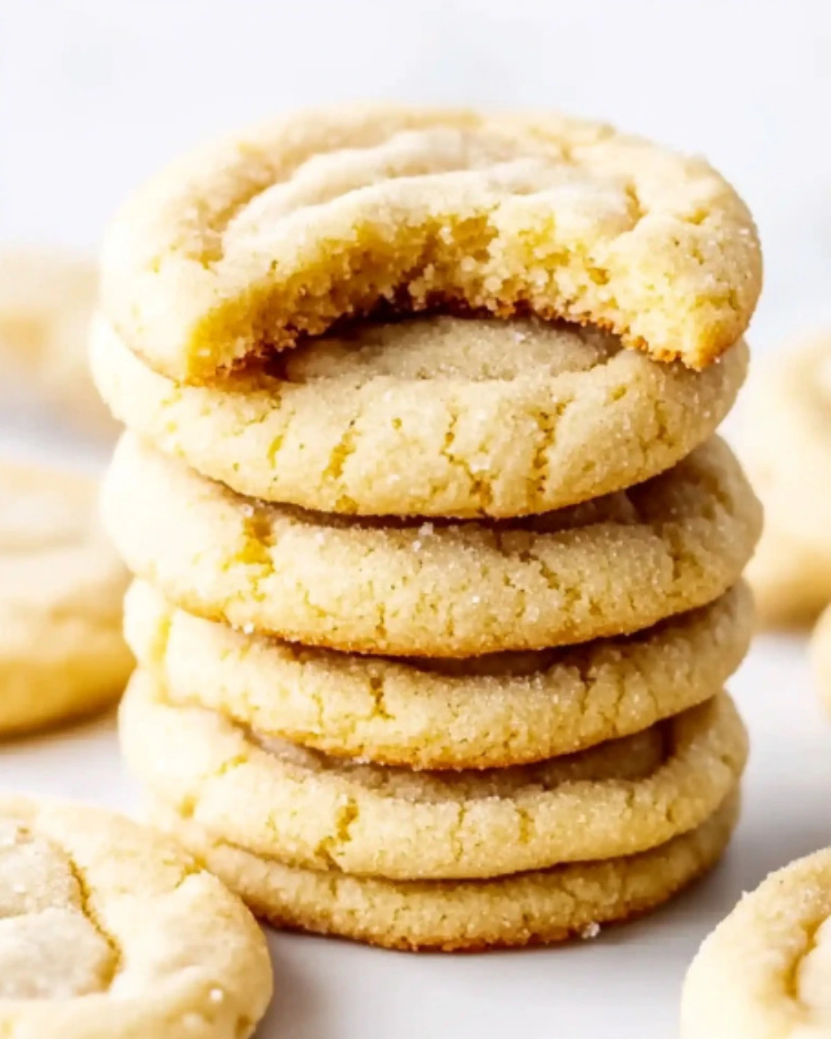 soft sugar cookies with a bite taken out of the top cookie