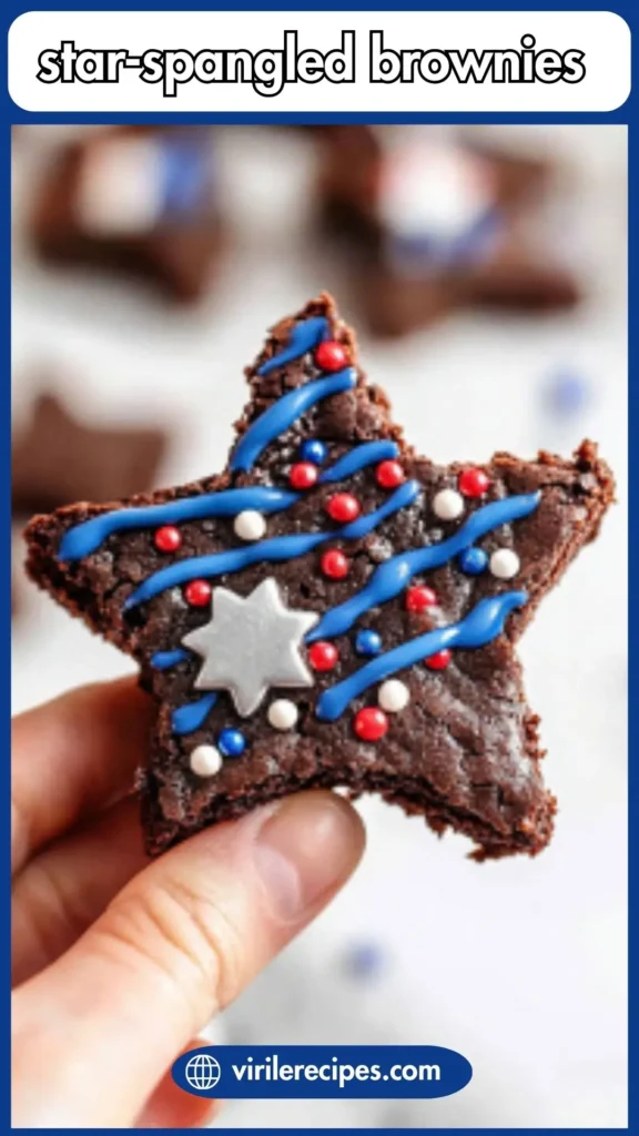Hand holding a star-shaped brownie with red, white, and blue sprinkles and a metallic silver star, perfect for Fourth of July parties.