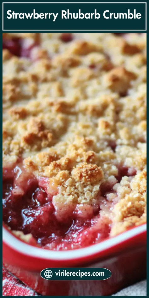 Close-up of freshly baked strawberry rhubarb crumble in a red ceramic dish with golden topping
