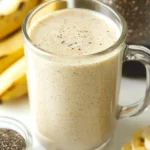 Creamy banana smoothie for weight loss in a clear glass mug with chia seeds and bananas
