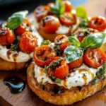 Close-up of creamy burrata bruschetta topped with cherry tomatoes and basil on toasted bread