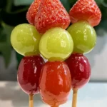Colorful strawberry, grape, and cherry Tanghulu skewers stacked neatly with glossy sugar coating