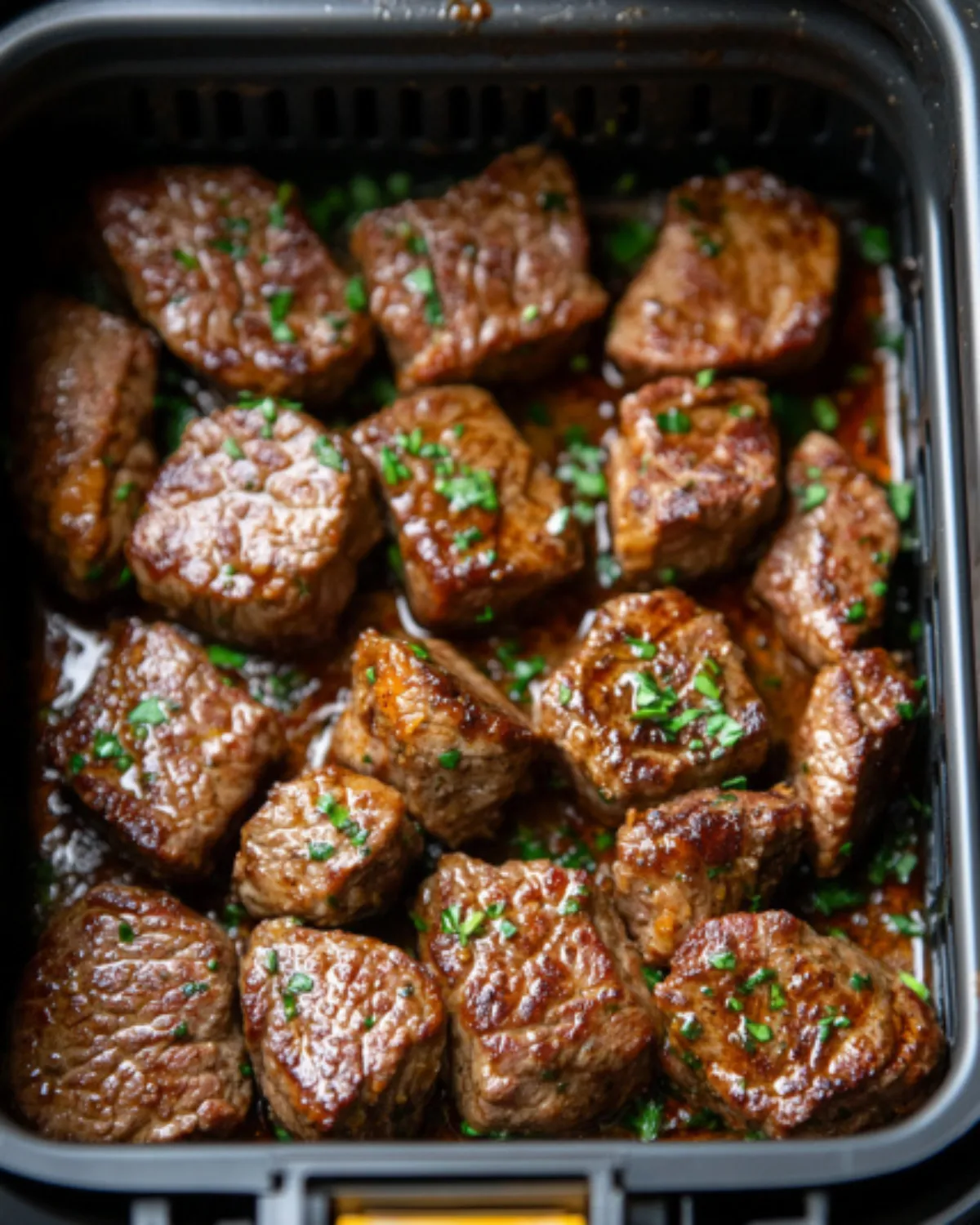 Air fryer garlic butter steak bites with crispy edges and fresh parsley