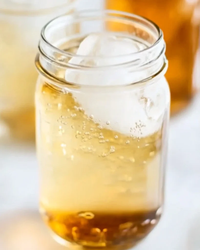 Golden cream soda in a mason jar filled with ice and gentle fizz