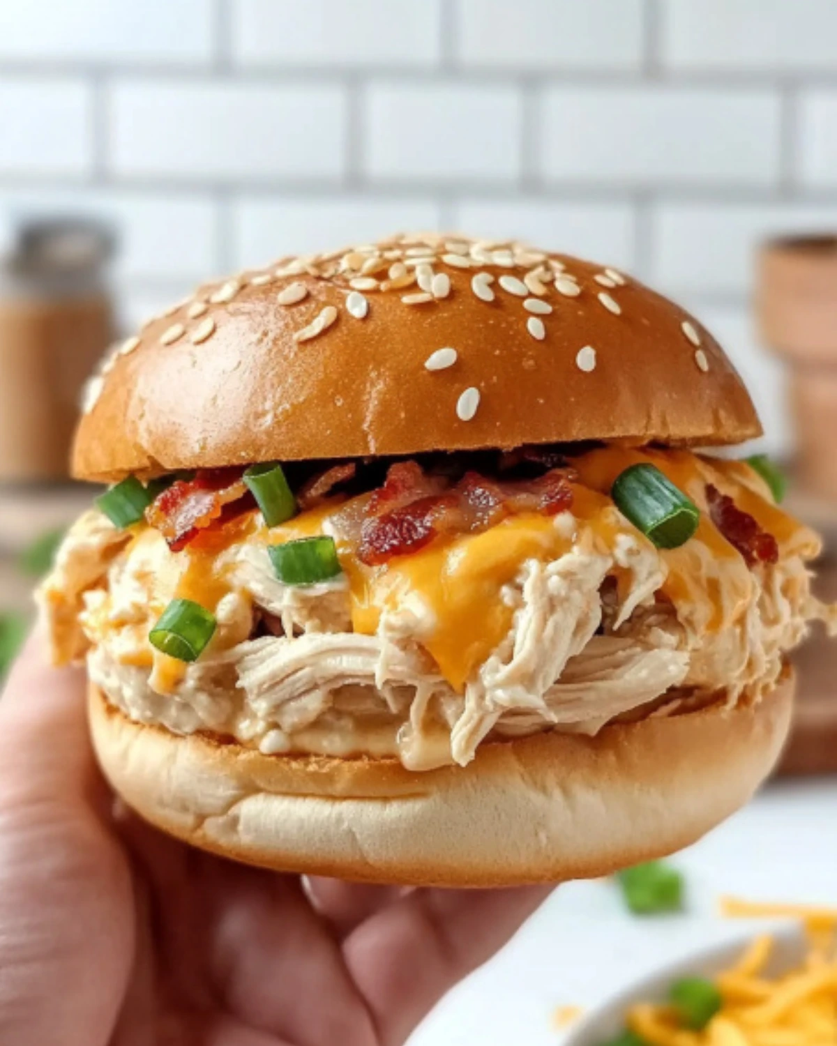 This creamy crockpot crack chicken sandwich is everything you want in a winter comfort meal—juicy chicken, smoky bacon, melted cheese, and ranch flavor in every bite.