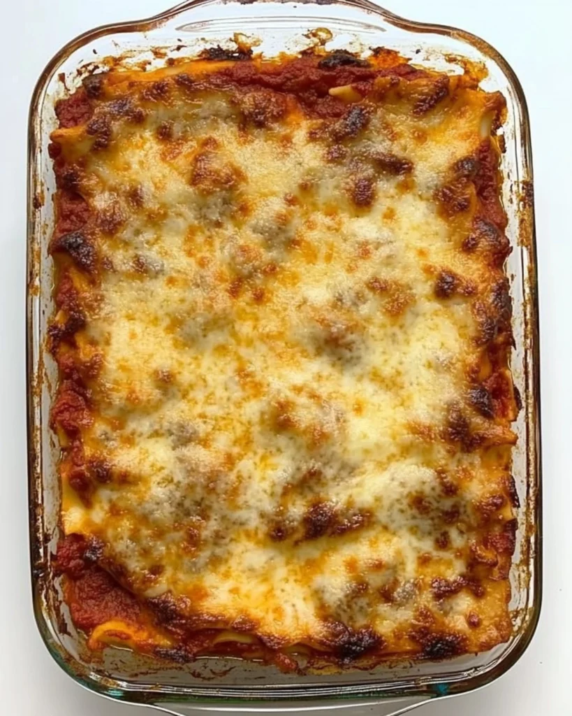 Freshly baked cheesy lasagna in a glass dish with golden crust and rich tomato sauce