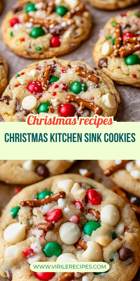 Christmas kitchen sink cookies with M&Ms, pretzels, white chocolate chips, and holiday sprinkles on parchment paper.