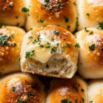 Freshly baked garlic butter dinner rolls with golden crust and parsley topping