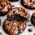 Chewy fudgy chocolate cookies with a crackled top, sea salt, and chocolate chips, with a gooey interior.