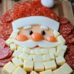 Festive Santa Claus face made from cheese cubes and pepperoni slices on a wooden board