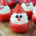 Fresh strawberries sliced and filled with whipped cream, arranged beautifully on a wooden surface for a festive and delicious treat.