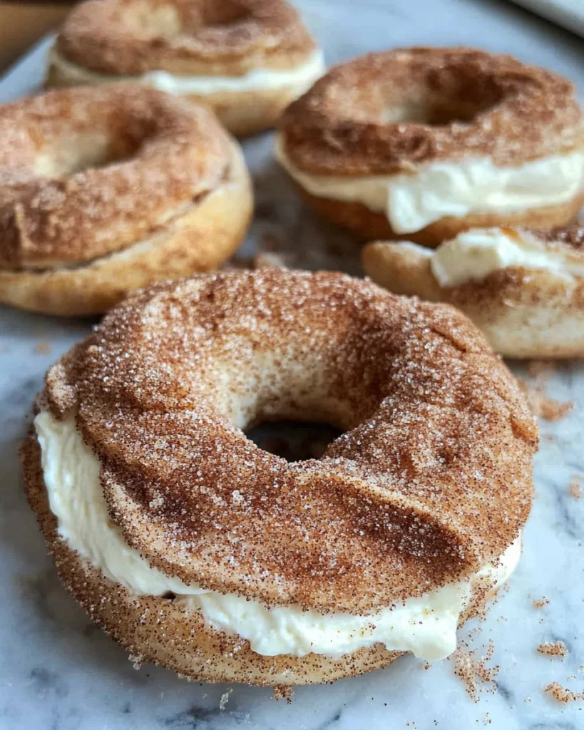 Close-up of a cinnamon crunch bagel with cream cheese on a baking tray