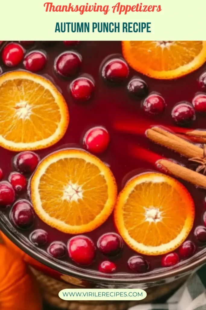 Close-up of cranberry apple cider autumn punch with orange slices and cinnamon in a glass bowl, text overlay reading "Autumn Punch Recipe"