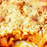 Baked sweet potato cobbler in a white dish with golden topping and soft sweet potatoes