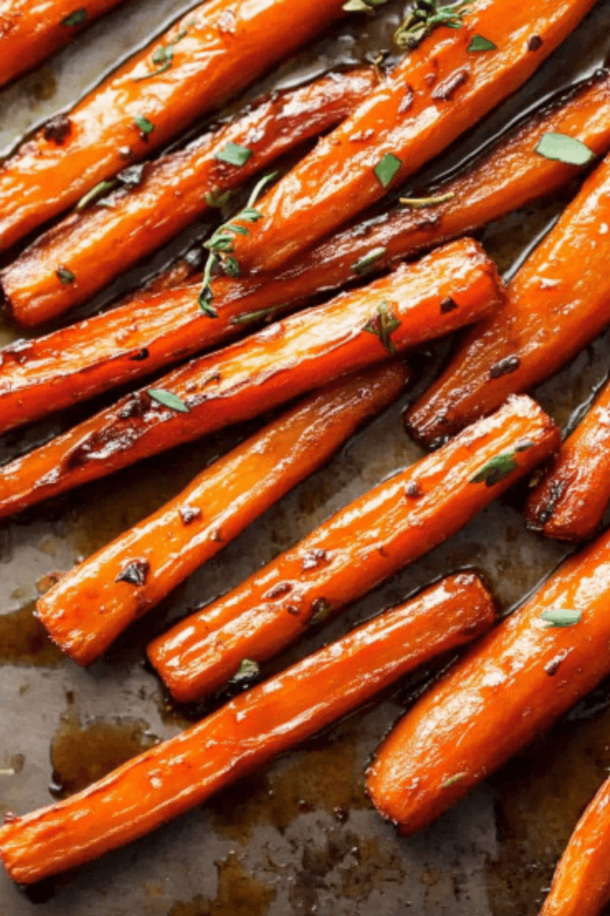 Honey balsamic roasted carrots caramelized with glaze and fresh herbs.