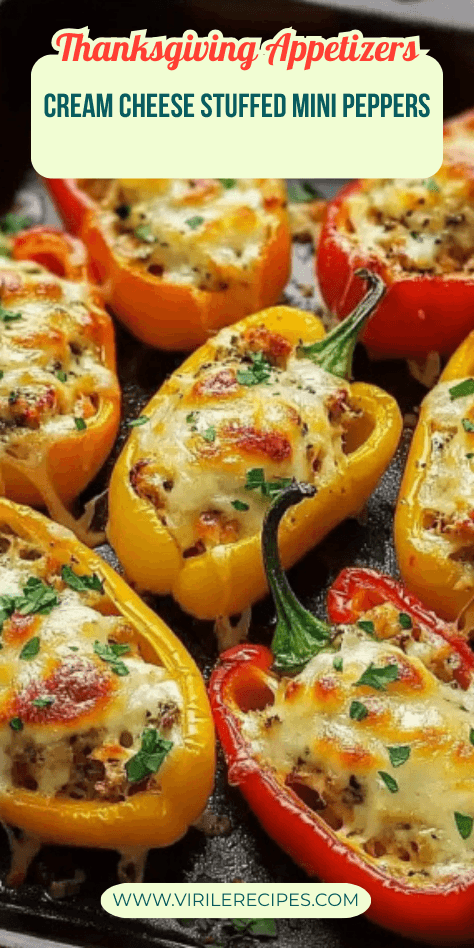 Baked cream cheese stuffed mini peppers with golden melted cheese, served as a colorful Thanksgiving appetizer.