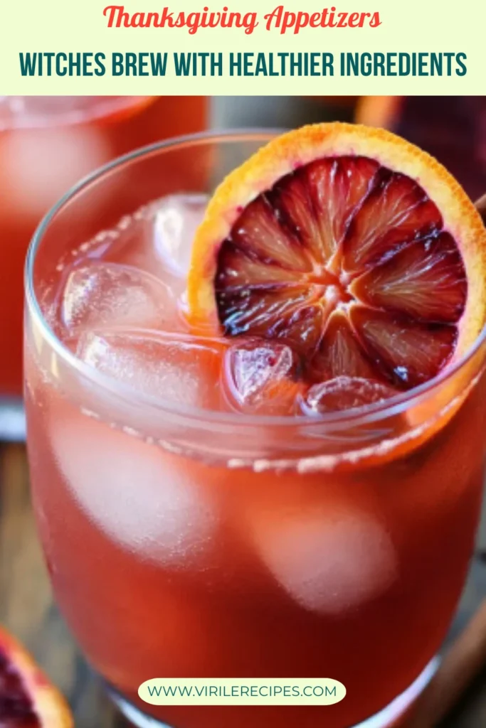 Healthy witches brew drink with blood orange slice and cinnamon stick, labeled Thanksgiving Appetizer