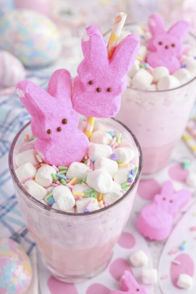 Glasses of Easter Bunny Punch topped with marshmallow Peeps, mini marshmallows, and colorful Easter sprinkles