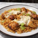 Cheesy chicken and rice with melted mozzarella, creamy sauce, and fresh herbs.