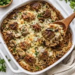 French Onion Meatballs and Rice served in a bowl with melted Gruyere cheese and sautéed mushrooms