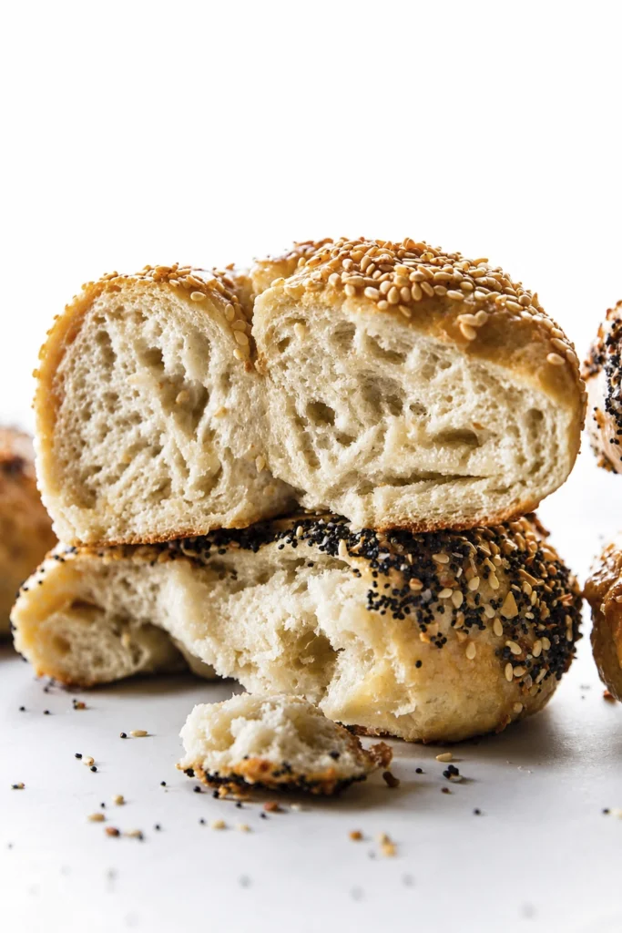 Fresh homemade everything and sesame bagels served with whipped cream cheese spread on toasted bagel halves.